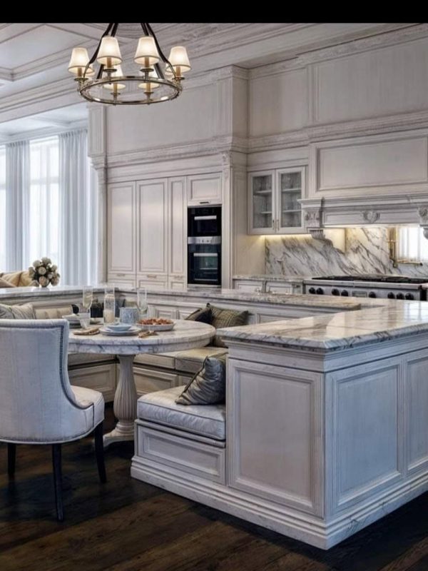 Luxurious white custom kitchen with marble countertops, elegant cabinetry, and classic design, perfect for a high-end home renovation or kitchen remodeling project.